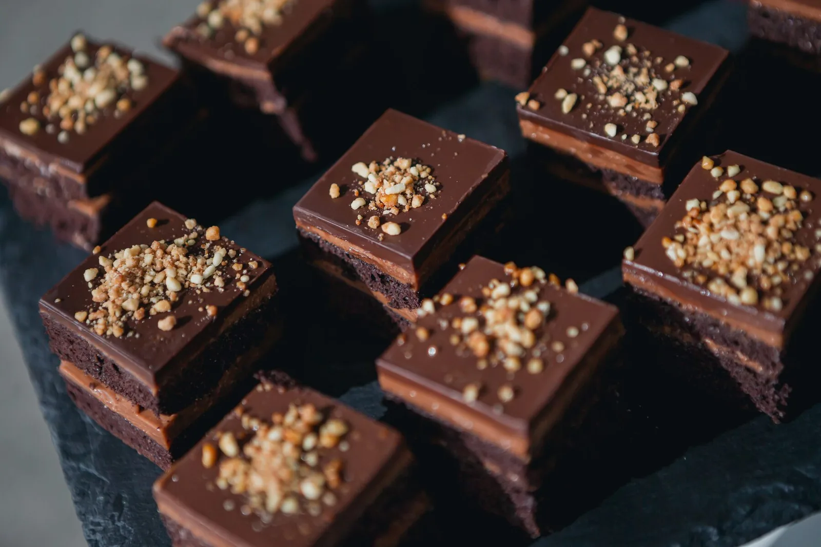 Chocolate mini slices with nuts on slate