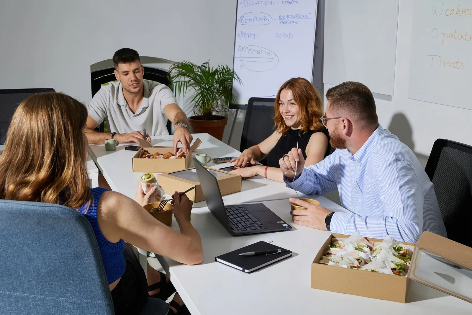 A team at a working lunch with Precise food boxes